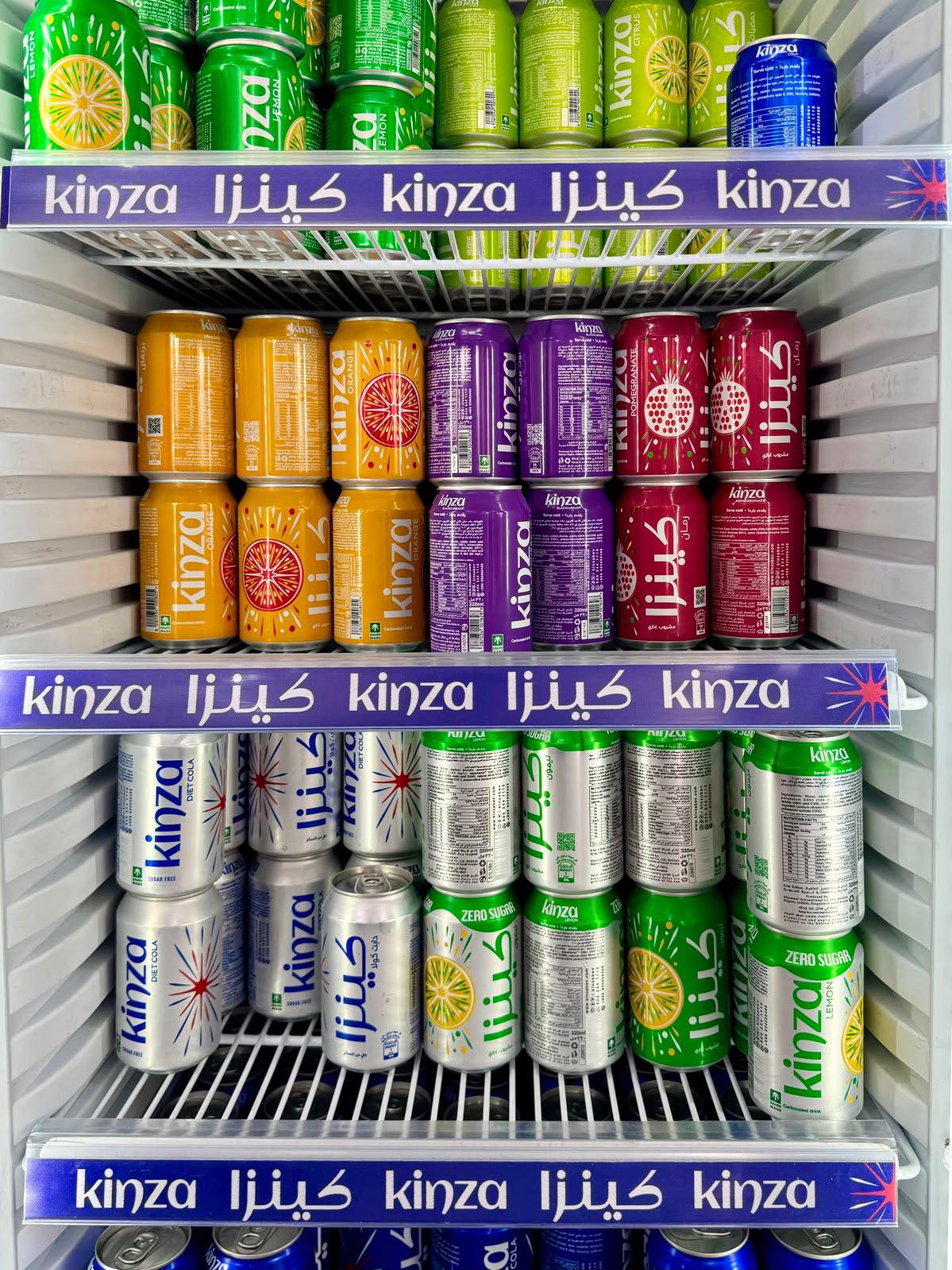 Kinza cans stocked in a fridge with Arabic and English facings